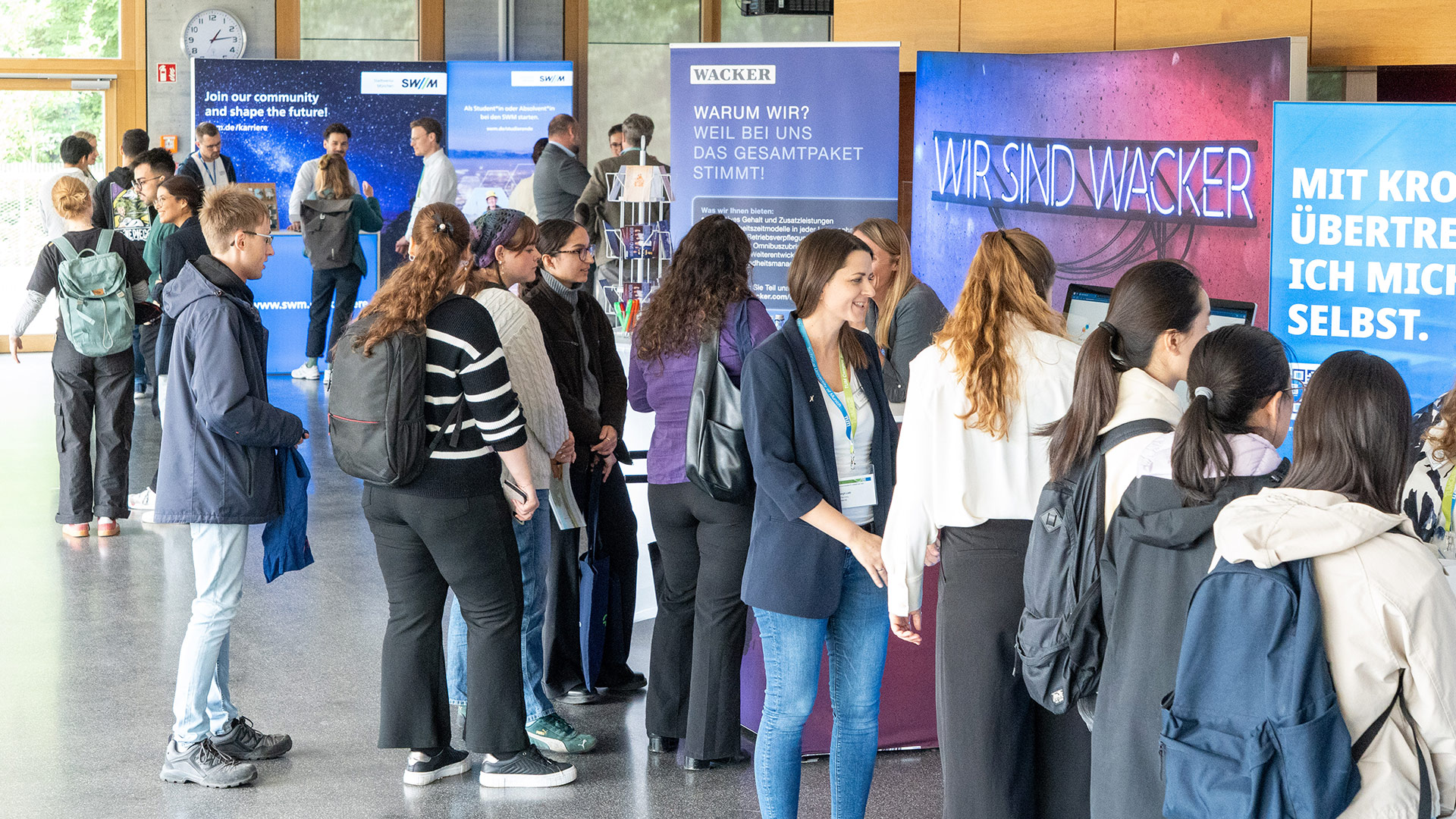 A group of people in front of stands at the Sustainability Career fair