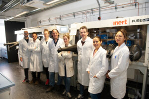 A group of scientists standing in a lab.
